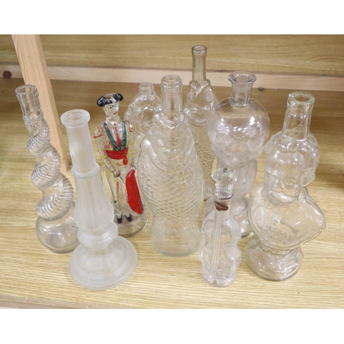 509 - Nine moulded glass bottles, including one coloured and formed as a matador tallest 33cmCONDITION: Pr... 