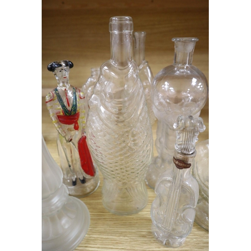 509 - Nine moulded glass bottles, including one coloured and formed as a matador tallest 33cmCONDITION: Pr... 
