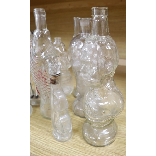 509 - Nine moulded glass bottles, including one coloured and formed as a matador tallest 33cmCONDITION: Pr... 