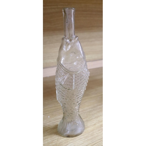 509 - Nine moulded glass bottles, including one coloured and formed as a matador tallest 33cmCONDITION: Pr... 