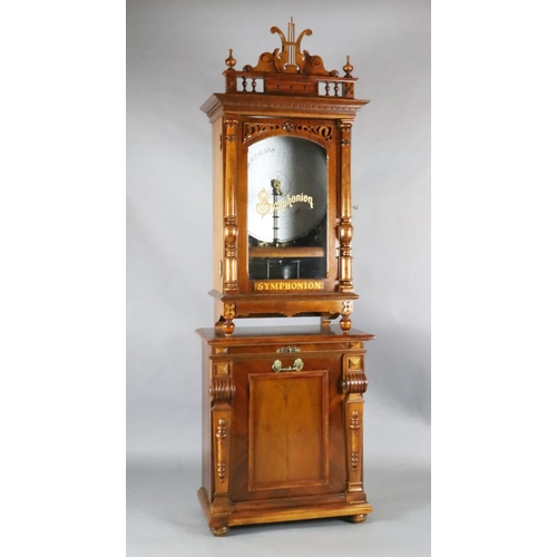 35 - A late 19th century German walnut cased upright Symphonion, with lyre shaped pediment, pilaster flan... 