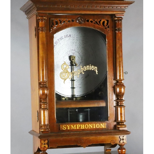 35 - A late 19th century German walnut cased upright Symphonion, with lyre shaped pediment, pilaster flan... 