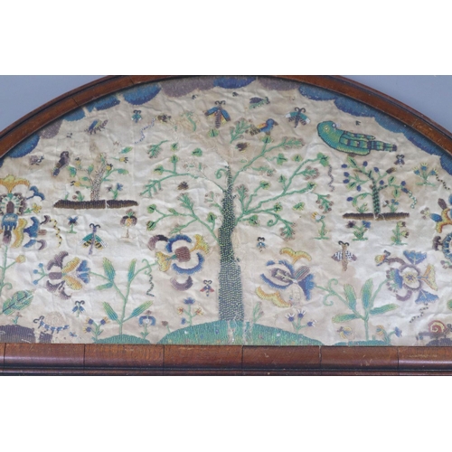 37 - A late 17th century silk and bead work arched panel, with central tree, birds, butterflies, exotic l... 