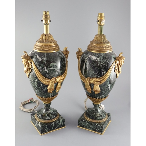 51 - A pair of early 20th century ormolu green marble table lamps, with ovular form with mask lug handles... 