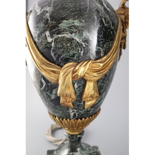 51 - A pair of early 20th century ormolu green marble table lamps, with ovular form with mask lug handles... 