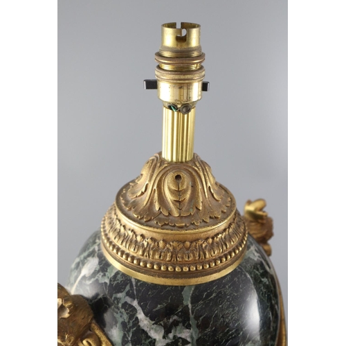 51 - A pair of early 20th century ormolu green marble table lamps, with ovular form with mask lug handles... 