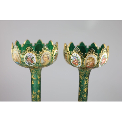 102 - A pair of Bohemian enamelled white overlaid green glass vases, late 19th century, with crenellated t... 