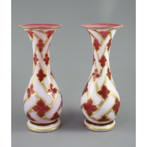 104 - A pair of Bohemian white and ruby overlaid glass baluster vases, late 19th century, decorated with g... 