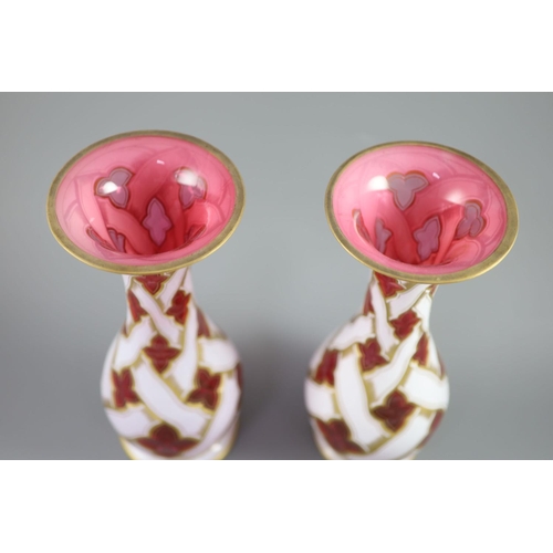 104 - A pair of Bohemian white and ruby overlaid glass baluster vases, late 19th century, decorated with g... 