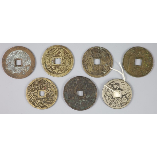 136 - China, a group of 7 bronze charms or amulets, Qing dynasty, each with a four character inscription o... 