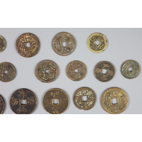 137 - China, a group of 26 bronze or brass charms or amulets, Qing dynasty, all with four character inscri... 