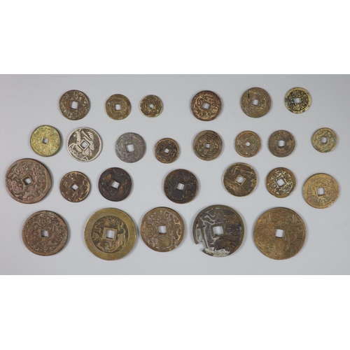 137 - China, a group of 26 bronze or brass charms or amulets, Qing dynasty, all with four character inscri... 