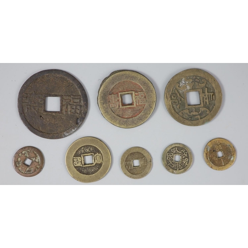 156 - China, 8 bronze charms or amulets, Qing dynasty, six with four characters obverse and two reverse, M... 