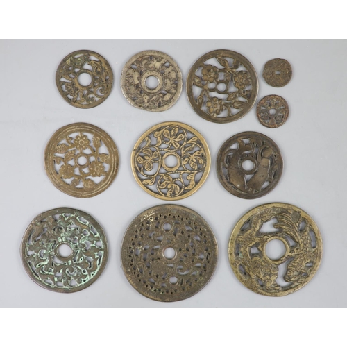 167 - China, 10 bronze open work charms or amulets, Qing dynasty or earlier, seven with plants and flowers... 