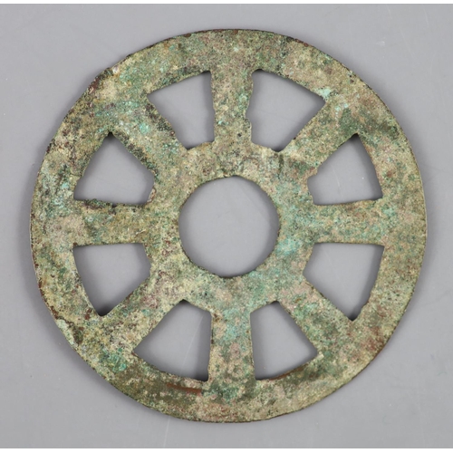 168 - China, a rare archaic bronze openwork Dharmachakra (wheel) charm, probably Han-Tang dynasty, 64mm, s... 