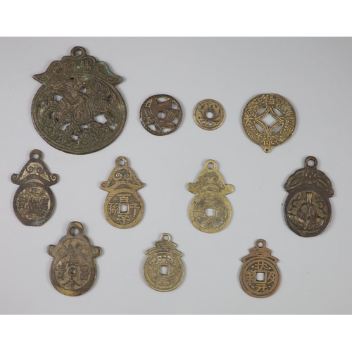 170 - China, 11 bronze charms or amulets, Qing dynasty or earlier, including an openwork pendant charm, bo... 