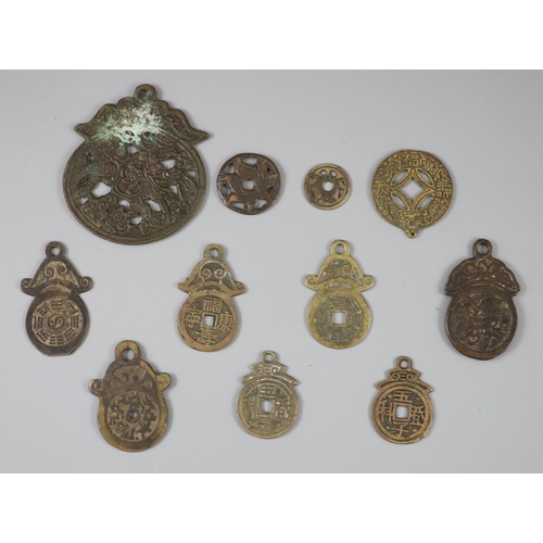 170 - China, 11 bronze charms or amulets, Qing dynasty or earlier, including an openwork pendant charm, bo... 