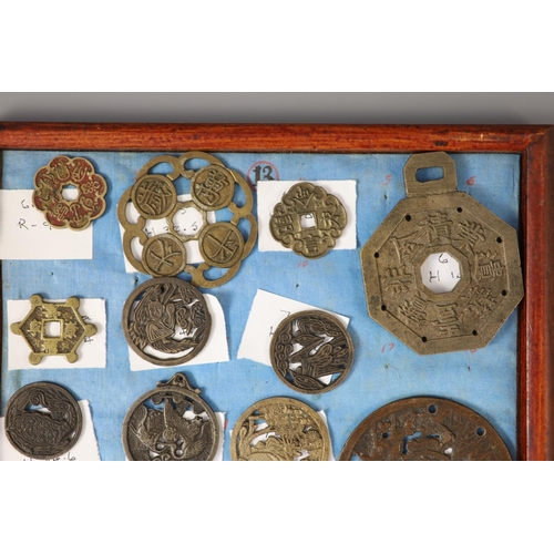 185 - A group of 99 Korean bronze and metal amulets or charms, 19th/20th century largest 70mmCONDITION: tr... 