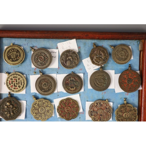 185 - A group of 99 Korean bronze and metal amulets or charms, 19th/20th century largest 70mmCONDITION: tr... 