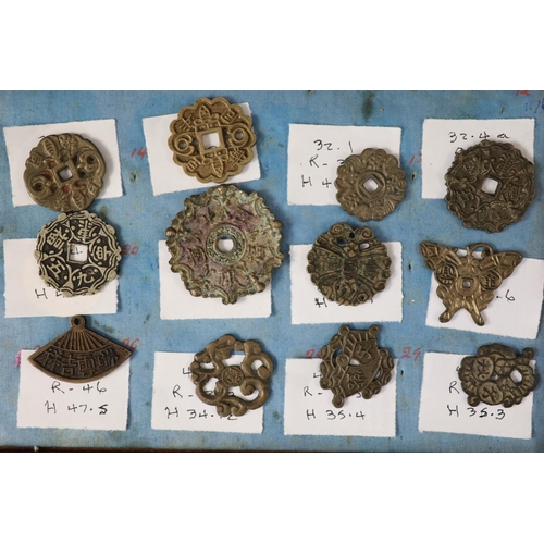 185 - A group of 99 Korean bronze and metal amulets or charms, 19th/20th century largest 70mmCONDITION: tr... 