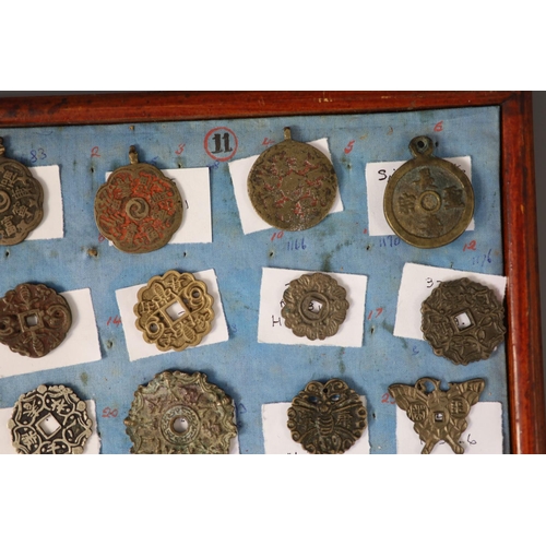 185 - A group of 99 Korean bronze and metal amulets or charms, 19th/20th century largest 70mmCONDITION: tr... 