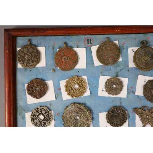 185 - A group of 99 Korean bronze and metal amulets or charms, 19th/20th century largest 70mmCONDITION: tr... 