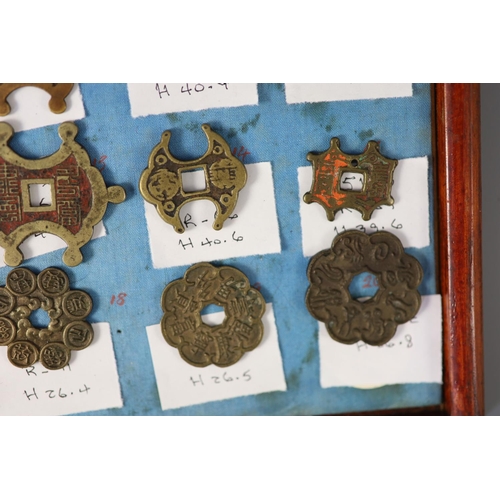 185 - A group of 99 Korean bronze and metal amulets or charms, 19th/20th century largest 70mmCONDITION: tr... 