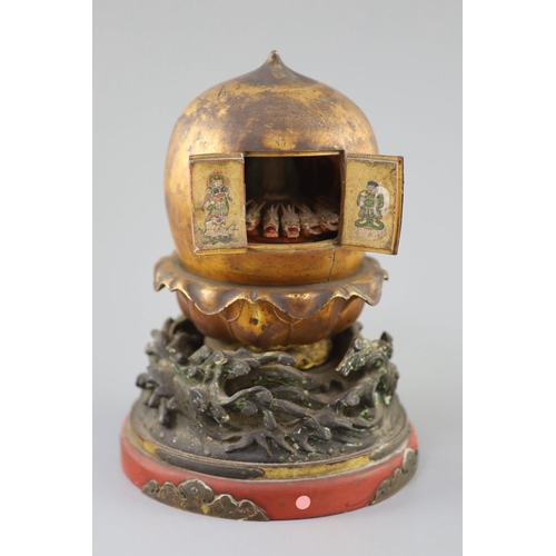 204 - A Japanese lacquer portable shrine (zushi), 19th century, of peach form opening to reveal a female i... 