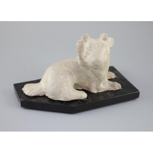 209 - A Chinese grey pottery figure of a recumbent dog, Han dynasty or later 23.5cm long, wood standCONDIT... 