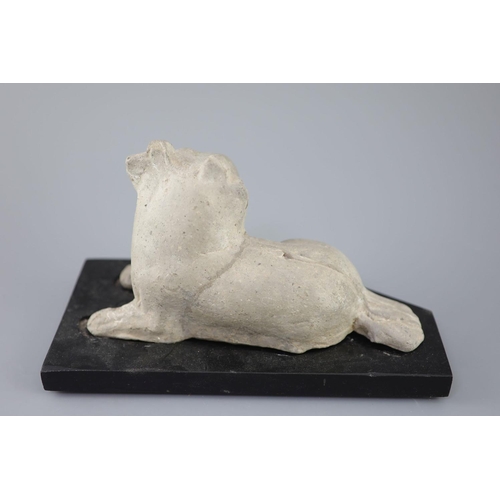 209 - A Chinese grey pottery figure of a recumbent dog, Han dynasty or later 23.5cm long, wood standCONDIT... 