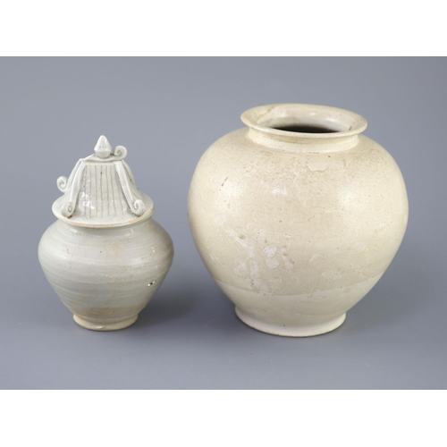 211 - A Chinese cream glazed ovoid jar, Tang dynasty and a Ding type jar and cover, Yuan dynasty, the larg... 