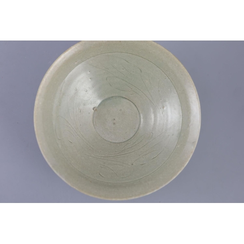 212 - A Chinese celadon bowl, Song-Yuan dynasty of conical form, the interior incised with foliage, 18.2cm... 