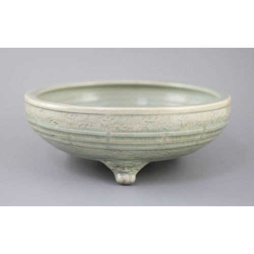 214 - A large Chinese Longquan celadon tripod censer, Ming dynasty, 15th century, unglazed patch to the ce... 