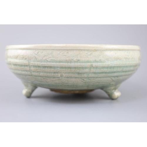 214 - A large Chinese Longquan celadon tripod censer, Ming dynasty, 15th century, unglazed patch to the ce... 