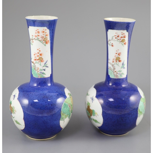 216 - A pair of Chinese powder blue famille verte bottle vases, Kangxi period (1662-1722), each painted to... 