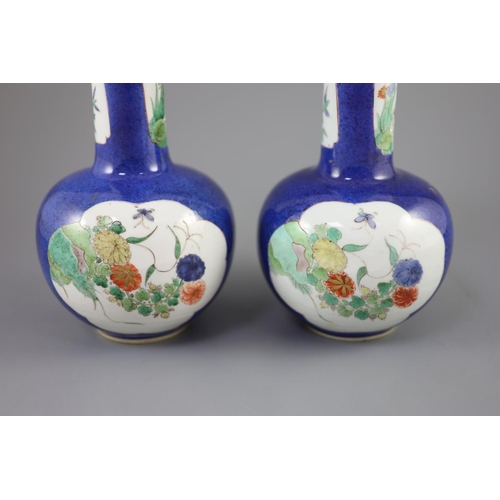 216 - A pair of Chinese powder blue famille verte bottle vases, Kangxi period (1662-1722), each painted to... 