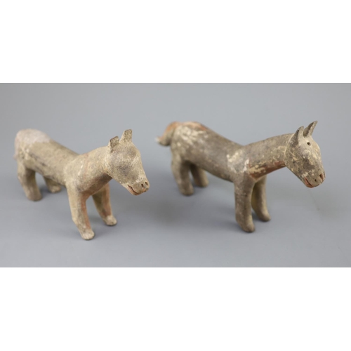 219 - A pair of Chinese grey pottery models of dogs, Han dynasty or later, 26cm long, repairs... 