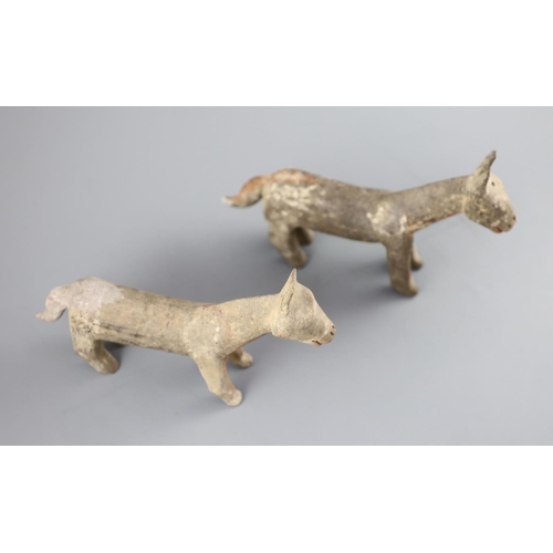 219 - A pair of Chinese grey pottery models of dogs, Han dynasty or later, 26cm long, repairs... 