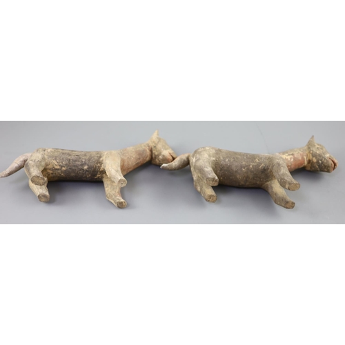 219 - A pair of Chinese grey pottery models of dogs, Han dynasty or later, 26cm long, repairs... 