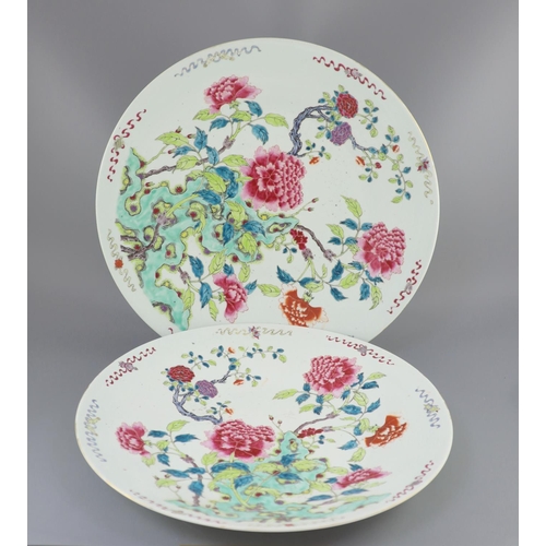 224 - A pair of large Chinese famille rose dishes, late 19th century, each painted with peonies and rockwo... 