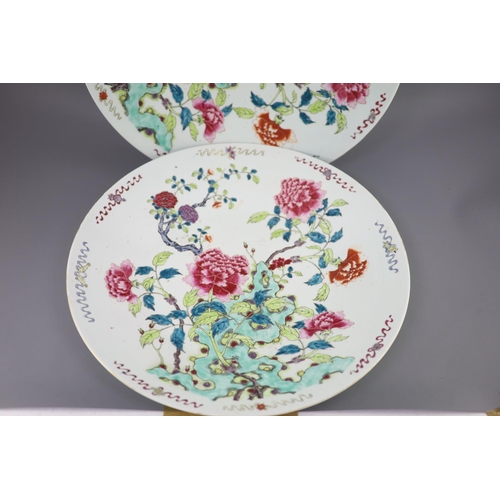 224 - A pair of large Chinese famille rose dishes, late 19th century, each painted with peonies and rockwo... 