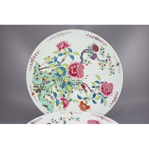 224 - A pair of large Chinese famille rose dishes, late 19th century, each painted with peonies and rockwo... 