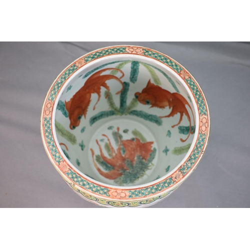 228 - A large Chinese famille verte goldfish bowl, late 19th century, the exterior well-painted with a bat... 