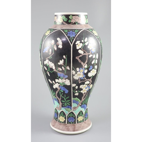 229 - A Chinese famille noire enamelled biscuit baluster vase and cover, 19th century, decorated in Kangxi... 