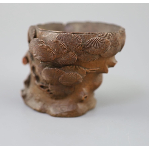 237 - A Chinese bamboo root 'pine' libation cup, 17th/18th century, carved in high relief and openwork as ... 