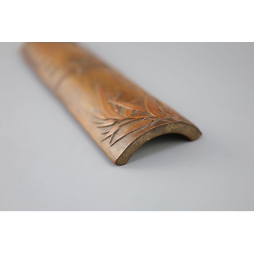 241 - A Chinese bamboo 'bamboo sprig' wrist rest, 18th century, carved in high relief with bamboo and inci... 