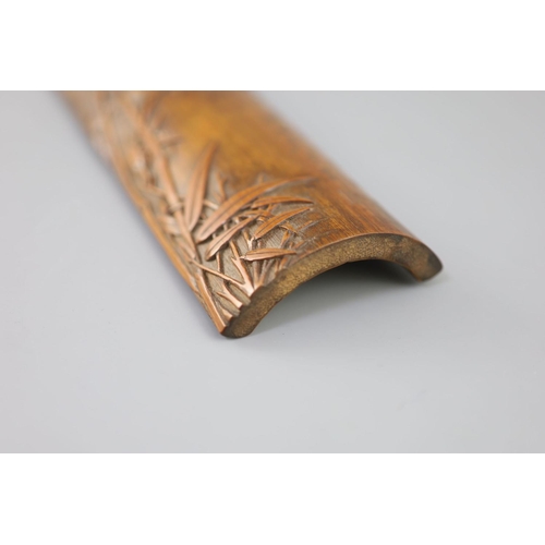 241 - A Chinese bamboo 'bamboo sprig' wrist rest, 18th century, carved in high relief with bamboo and inci... 