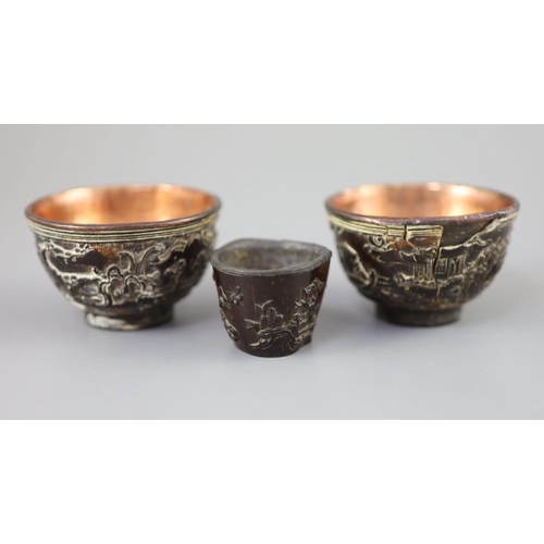 245 - A pair of Chinese coconut 'landscape' cups and a similar peach-shaped cup, 18th/19th century, the pa... 