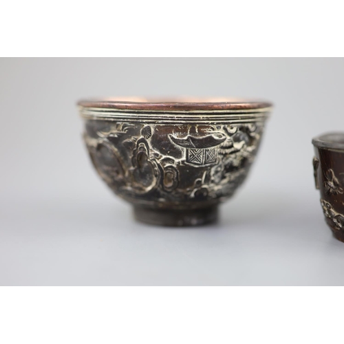 245 - A pair of Chinese coconut 'landscape' cups and a similar peach-shaped cup, 18th/19th century, the pa... 