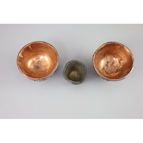 245 - A pair of Chinese coconut 'landscape' cups and a similar peach-shaped cup, 18th/19th century, the pa... 